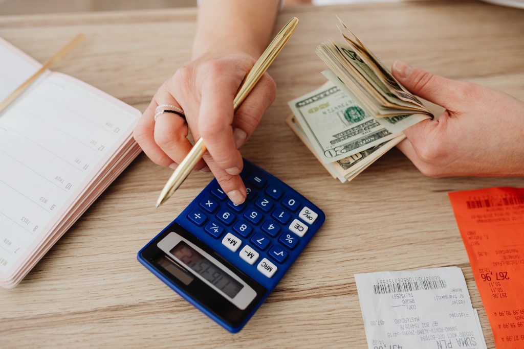 Personal Budget Planning with Calculator Cash Receipts and US Dollar Bills